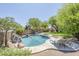 Sparkling pool with rock waterfall and mature landscaping at 31259 N 42Nd Pl, Cave Creek, AZ 85331