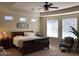 Inviting bedroom with a comfortable bed, side table, and a large window at 35401 N Via Tramonto St, Phoenix, AZ 85086