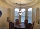 Elegant dining room featuring a tray ceiling, chandelier lighting, and large windows at 35401 N Via Tramonto St, Phoenix, AZ 85086