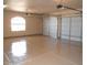 Spacious garage with two white garage doors, a large window, polished floor, and ample lighting at 35401 N Via Tramonto St, Phoenix, AZ 85086