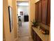 Hallway featuring granite countertops and cabinets, leading to an office or bedroom at 35401 N Via Tramonto St, Phoenix, AZ 85086
