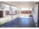 A covered back patio, enclosed by a decorative metal fence and offering a view of the backyard, providing a shady outdoor space at 3651 W Mariposa St, Phoenix, AZ 85019