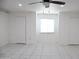 Bright bedroom with tiled floor, a ceiling fan, and multiple closets for ample storage at 3651 W Mariposa St, Phoenix, AZ 85019