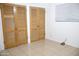 Bedroom with tiled floors and closet with bi-fold doors for convenient storage space at 3651 W Mariposa St, Phoenix, AZ 85019