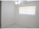 Bright and airy bedroom featuring neutral walls, ceiling fan, and tile flooring at 3651 W Mariposa St, Phoenix, AZ 85019