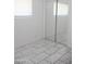 Clean bedroom with tile flooring, mirrored closet doors, and ample natural light at 3651 W Mariposa St, Phoenix, AZ 85019