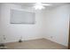 Simple bedroom with tile floors, ceiling fan, and a large window at 3651 W Mariposa St, Phoenix, AZ 85019