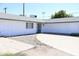 Cozy house with a gray roof, a gated front door, a garage, and a spacious driveway at 3651 W Mariposa St, Phoenix, AZ 85019