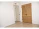Hallway with tile flooring and wooden doors leading to various rooms at 3651 W Mariposa St, Phoenix, AZ 85019