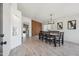 Bright dining area featuring modern light fixture, stylish wood accent wall, and contemporary decor at 4440 E Tether Trl, Phoenix, AZ 85050