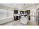Bright kitchen featuring stainless steel appliances, black cabinets, a white island, and modern fixtures at 4440 E Tether Trl, Phoenix, AZ 85050