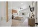 Spacious main bedroom with a wood accent wall, neutral tones, and bright natural light at 4440 E Tether Trl, Phoenix, AZ 85050