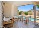 Relaxing covered patio with comfortable seating, perfect for outdoor dining and overlooking the pool at 4440 E Tether Trl, Phoenix, AZ 85050
