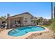 Backyard with a private pool, covered patio, and lush landscaping; perfect for relaxation and entertaining at 4440 E Tether Trl, Phoenix, AZ 85050