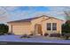 Charming single-story home with a stucco exterior, tile roof, arched entryway, and a two-car garage at 5185 N 87Th Dr, Glendale, AZ 85305
