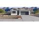 Charming single-story home showcasing a well-maintained lawn, 2-car garage, and mountain views at 5496 E Axle Ln, San Tan Valley, AZ 85140