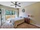 Bedroom featuring a ceiling fan, sliding glass door to balcony, and neutral carpet and walls at 5640 E Bell Rd # 1034, Scottsdale, AZ 85254