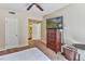 Bedroom with a TV, dresser, ceiling fan, and ensuite bathroom, all with neutral walls at 5640 E Bell Rd # 1034, Scottsdale, AZ 85254