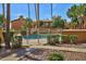 Gated community pool area with desert landscaping and attractive stucco buildings in the background at 5640 E Bell Rd # 1034, Scottsdale, AZ 85254