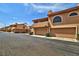 Multi-Gathering residential exterior with private garages, meticulous landscape, and ample parking at 5640 E Bell Rd # 1034, Scottsdale, AZ 85254