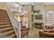 Cozy living room showcases a staircase, fireplace, comfortable seating, and access to the kitchen at 5640 E Bell Rd # 1034, Scottsdale, AZ 85254