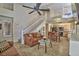Spacious living room featuring a ceiling fan, staircase, and views into kitchen and upper level at 5640 E Bell Rd # 1034, Scottsdale, AZ 85254