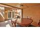 Inviting covered patio features tile flooring, wood beams, ceiling fan, and a charming dining set for outdoor enjoyment at 5640 E Bell Rd # 1034, Scottsdale, AZ 85254