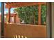 Enclosed patio view showcases lush greenery and the exterior architecture, framing a tranquil outdoor space at 5640 E Bell Rd # 1034, Scottsdale, AZ 85254