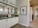 Elegant bathroom boasting double vanities, black hardware, and white cabinets for a functional space at 6190 N Sunrise Ln, Buckeye, AZ 85396