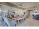 Open-concept living room flows into dining, showcasing stylish furnishings and access to the outdoor patio at 6190 N Sunrise Ln, Buckeye, AZ 85396