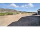Views of the lush green golf course and scenic Arizona mountains from the backyard at 6190 N Sunrise Ln, Buckeye, AZ 85396