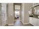 Modern bathroom with a glass shower, a stone floor, and an ensuite bedroom at 6190 N Sunrise Ln, Buckeye, AZ 85396
