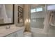 Bright bathroom with white subway tile, framed art, a shower with tub, and hanging towels at 6190 N Sunrise Ln, Buckeye, AZ 85396