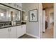 Modern bathroom with a double vanity and a framed art piece at 6190 N Sunrise Ln, Buckeye, AZ 85396
