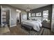 Modern bedroom with decorative lighting, a patterned rug, and an ensuite bathroom at 6190 N Sunrise Ln, Buckeye, AZ 85396