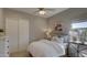 Cozy bedroom with a ceiling fan, slider closet doors, and a window with natural light at 6190 N Sunrise Ln, Buckeye, AZ 85396