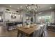 Open-concept dining area adjacent to kitchen, with a modern chandelier and seating for six at 6190 N Sunrise Ln, Buckeye, AZ 85396