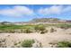 Panoramic view of the lush green golf course set against a backdrop of majestic mountains at 6190 N Sunrise Ln, Buckeye, AZ 85396