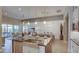 Open concept kitchen with stainless steel appliances and a view to the dining and living area at 6190 N Sunrise Ln, Buckeye, AZ 85396