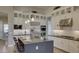 Elegant kitchen with stainless appliances, a center island, and sleek white cabinetry at 6190 N Sunrise Ln, Buckeye, AZ 85396
