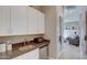 Convenient kitchenette with sleek white cabinets, modern appliances, and a stylish countertop for easy meal prep at 6190 N Sunrise Ln, Buckeye, AZ 85396