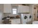 Well-organized laundry room with ample storage, workspace, and modern appliances for efficient chores at 6190 N Sunrise Ln, Buckeye, AZ 85396