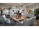 Bright and airy living room featuring an open floor plan with views to the kitchen and dining areas at 6190 N Sunrise Ln, Buckeye, AZ 85396