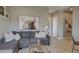 Comfortable living room with stylish sectional sofa, modern decor, and ample natural light for a welcoming space at 6190 N Sunrise Ln, Buckeye, AZ 85396