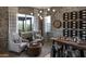 Chic wine room with custom storage, elegant seating, and ambient lighting for a sophisticated tasting experience at 6190 N Sunrise Ln, Buckeye, AZ 85396