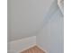 Slanted attic storage space with neutral carpeting and blank white walls at 6843 S 9Th Ave, Phoenix, AZ 85041