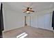 Empty carpeted bedroom with ceiling fan and closet at 6843 S 9Th Ave, Phoenix, AZ 85041