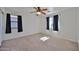 Spacious bedroom with carpet, a ceiling fan, and two windows offering natural light at 6843 S 9Th Ave, Phoenix, AZ 85041
