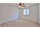 Cozy carpeted bedroom with ceiling fan and window at 6843 S 9Th Ave, Phoenix, AZ 85041