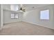 Spacious bedroom with two windows, a ceiling fan, and neutral carpet at 6843 S 9Th Ave, Phoenix, AZ 85041